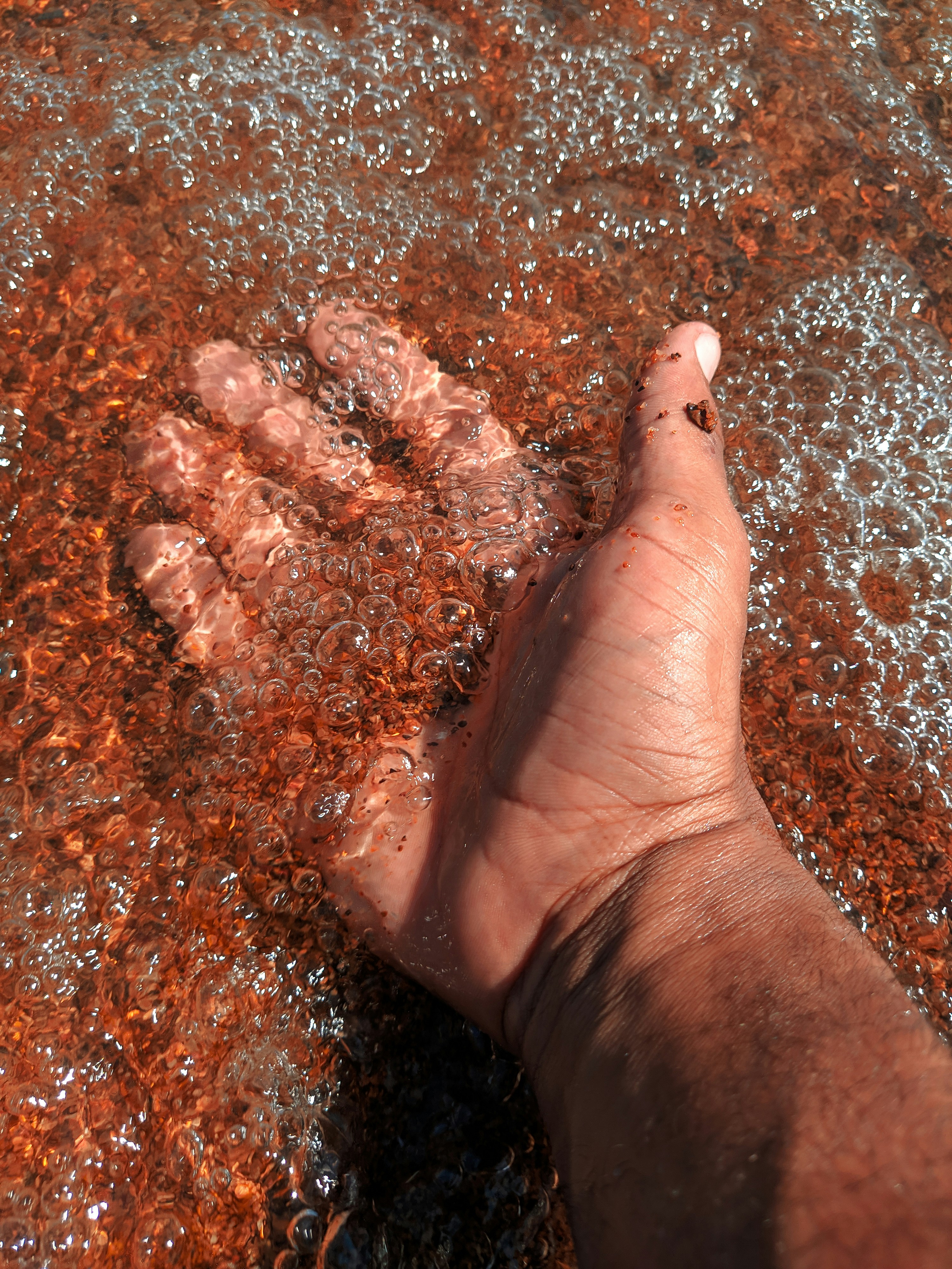 Picture of hand in water, showing someone taking real action in therapy